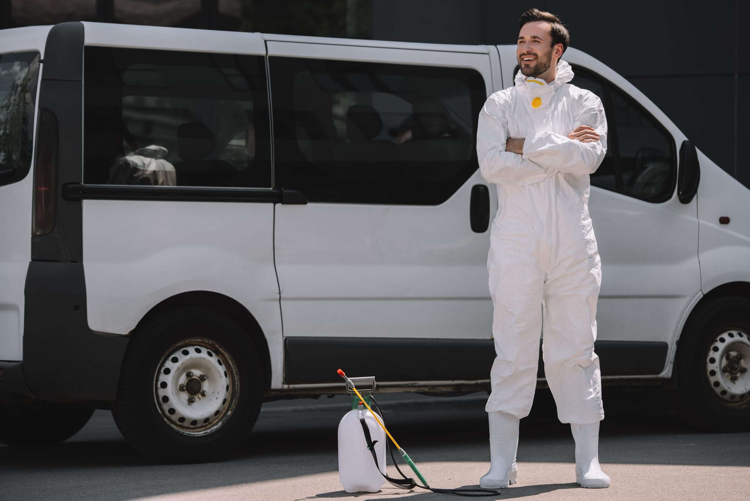 Reliant Pest Control technician in uniform beside service vehicle