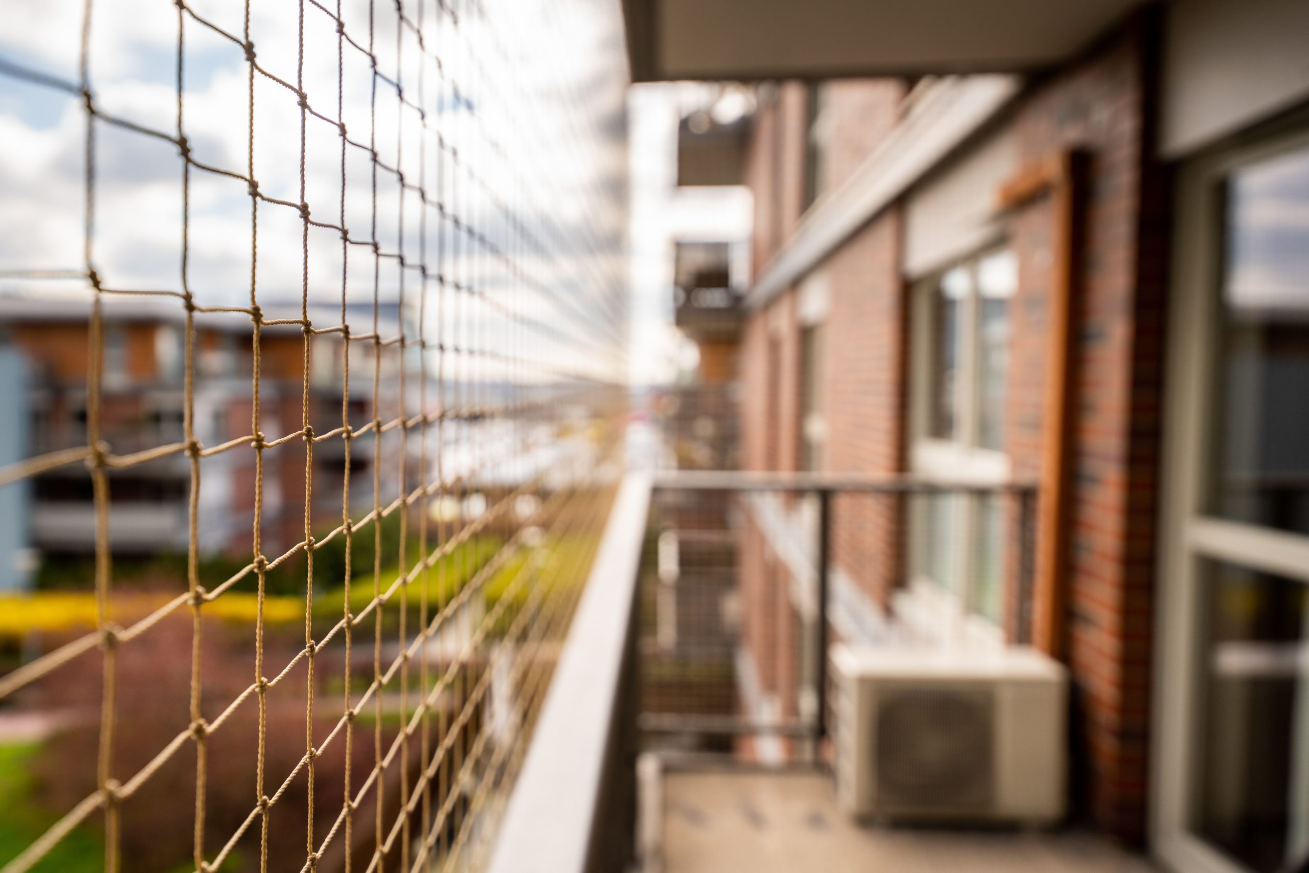 Bird netting installation on residential balcony for pigeon control